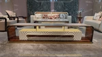 Architectural TV Stand with Sculpted Relief Panels Natural Wood Veneer Open Display Shelves and Soft Ambient Lighting